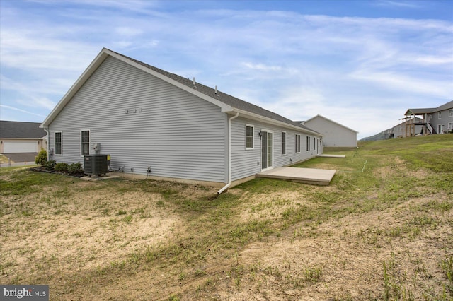 view of property exterior with central air condition unit and a lawn