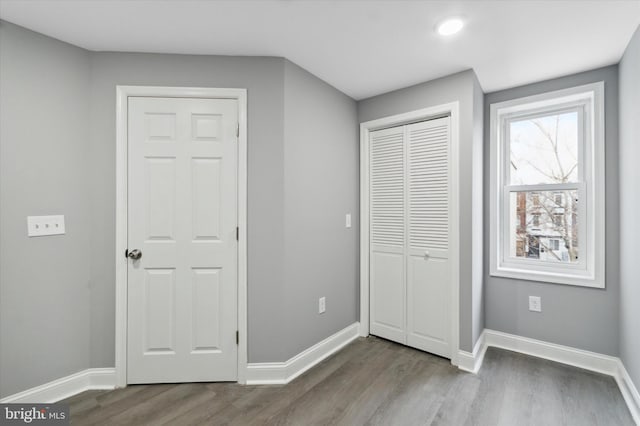 unfurnished bedroom with dark wood-type flooring