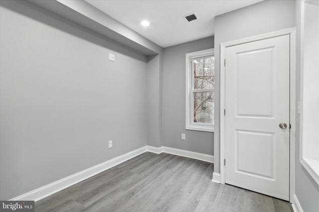 unfurnished room with light wood-type flooring