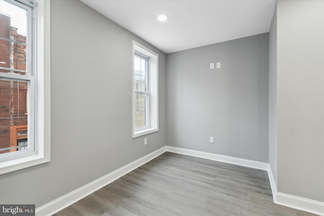 spare room with hardwood / wood-style flooring