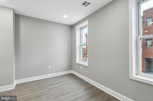 unfurnished room with light wood-type flooring