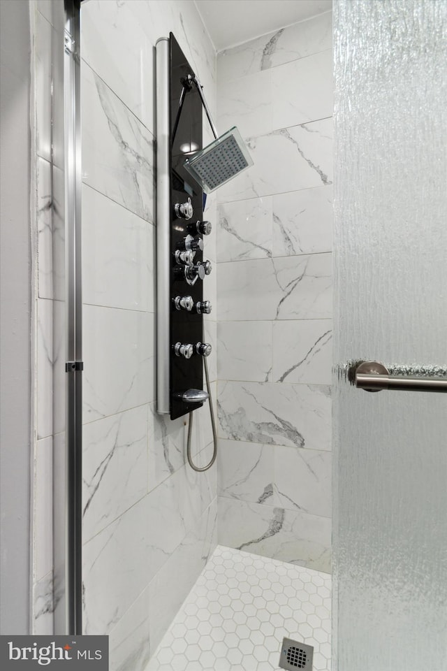 bathroom with a tile shower