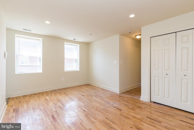 unfurnished bedroom featuring a closet and light hardwood / wood-style floors