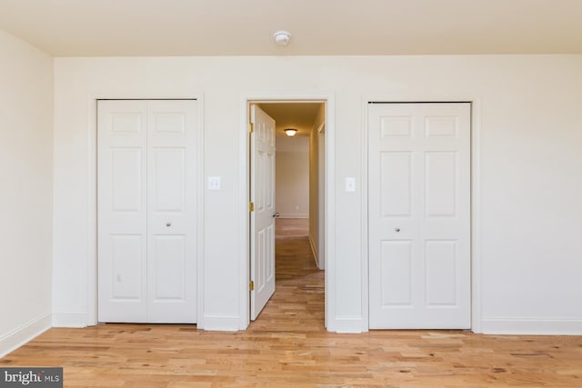 unfurnished bedroom with light wood-type flooring