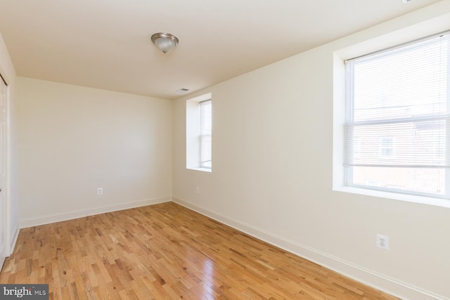 spare room with plenty of natural light and light wood-type flooring