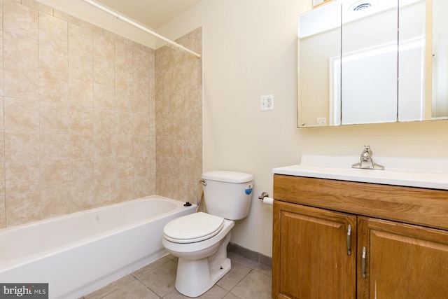 full bathroom featuring tile flooring, toilet, tiled shower / bath, and vanity with extensive cabinet space