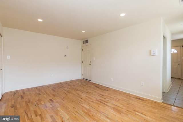 empty room with light hardwood / wood-style floors