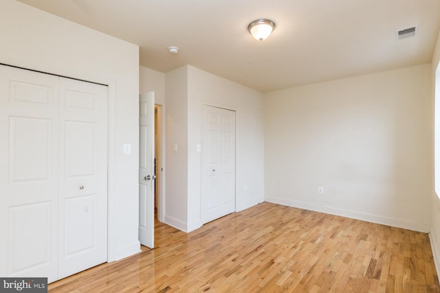 unfurnished bedroom featuring light wood-type flooring