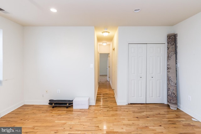 unfurnished bedroom featuring a closet and light hardwood / wood-style flooring