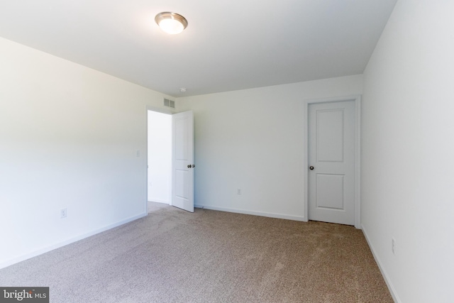 unfurnished room with light colored carpet