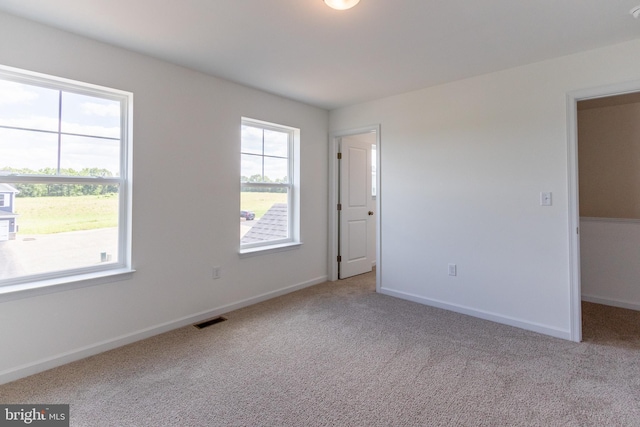 unfurnished room with light colored carpet