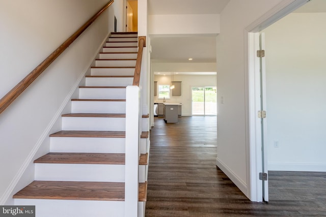 staircase with hardwood / wood-style floors