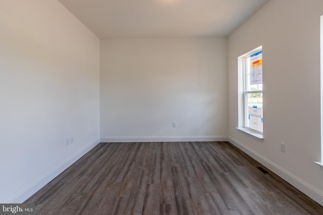 unfurnished room featuring dark hardwood / wood-style floors