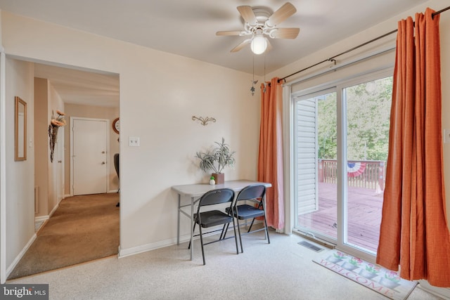 carpeted office featuring ceiling fan