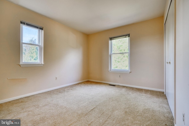 unfurnished room with light colored carpet