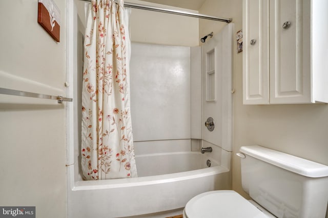 bathroom with shower / bath combo and toilet