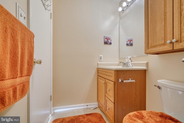 bathroom featuring large vanity and toilet