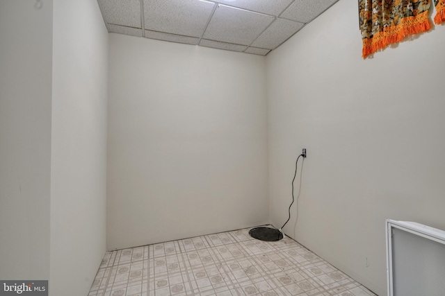 tiled empty room with a drop ceiling