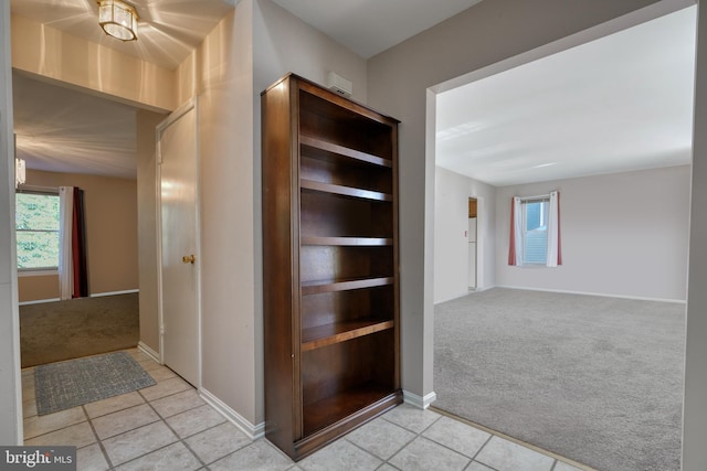 corridor featuring light tile floors