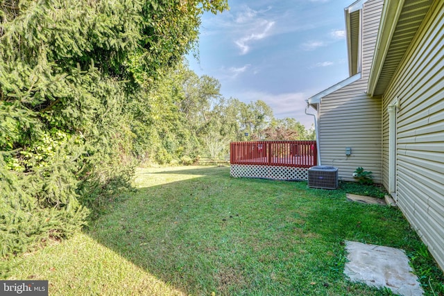 view of yard with a deck and central air condition unit