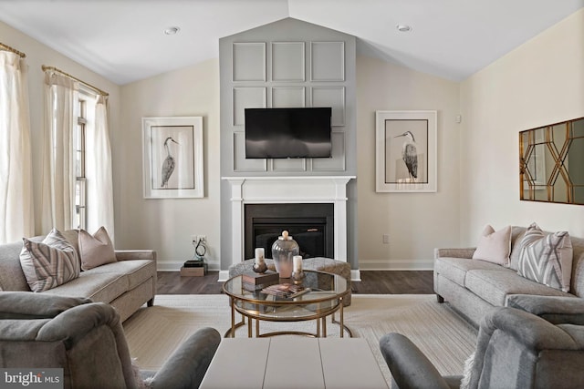 living room with dark hardwood / wood-style floors and vaulted ceiling