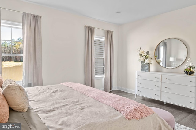 bedroom with dark wood-type flooring