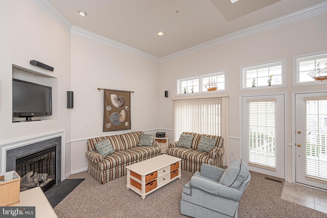 living room with crown molding, carpet floors, and a healthy amount of sunlight