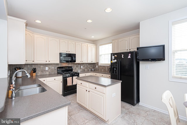 kitchen featuring a kitchen island, light tile flooring, black appliances, backsplash, and sink