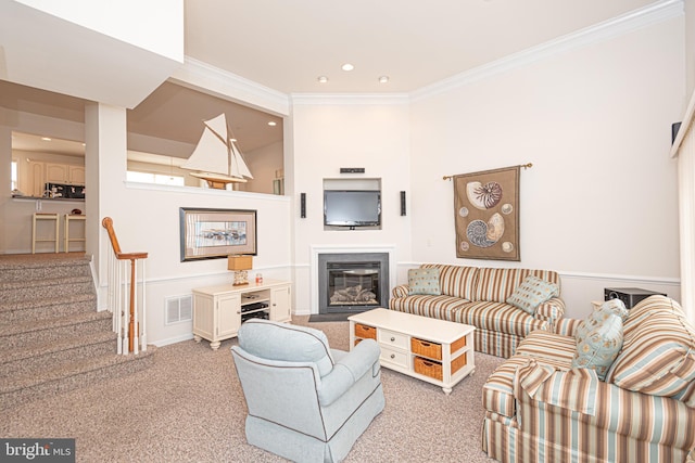 living room featuring ornamental molding and light carpet