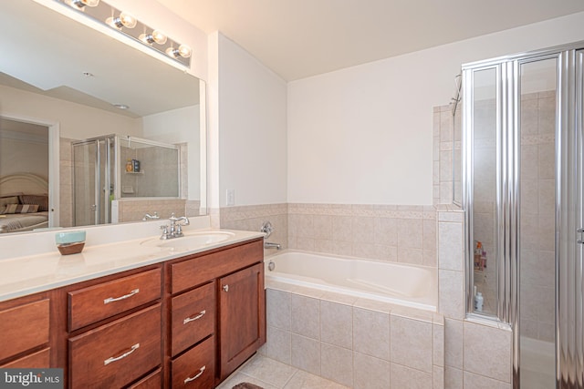 bathroom featuring tile flooring, shower with separate bathtub, and oversized vanity