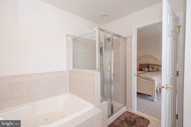 bathroom with shower with separate bathtub and tile floors