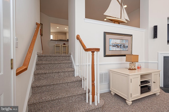 stairway with dark colored carpet