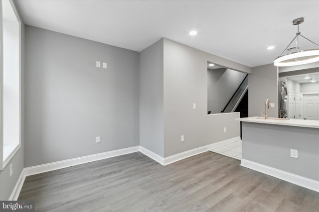 empty room with sink and light hardwood / wood-style flooring