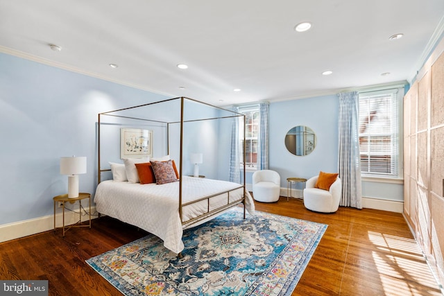 bedroom with ornamental molding, hardwood / wood-style flooring, and multiple windows