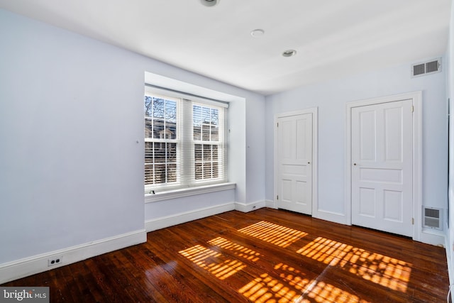 empty room with dark hardwood / wood-style floors