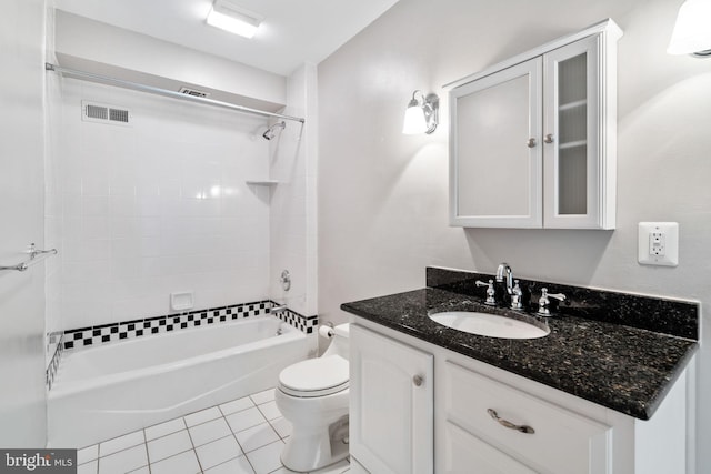 full bathroom with vanity, toilet, tile floors, and tiled shower / bath combo