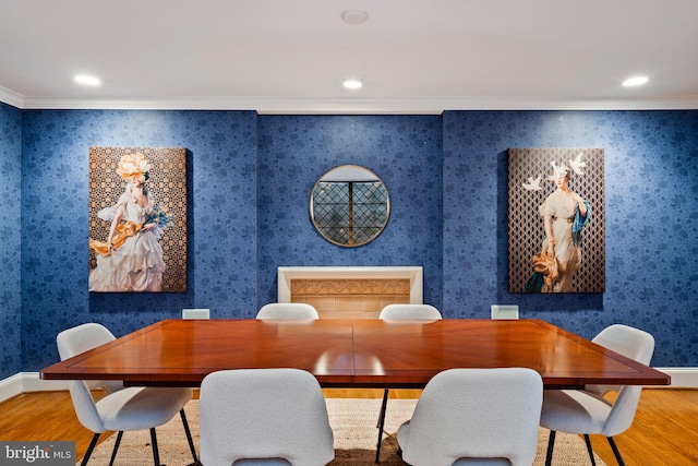 dining area featuring ornamental molding and light hardwood / wood-style floors