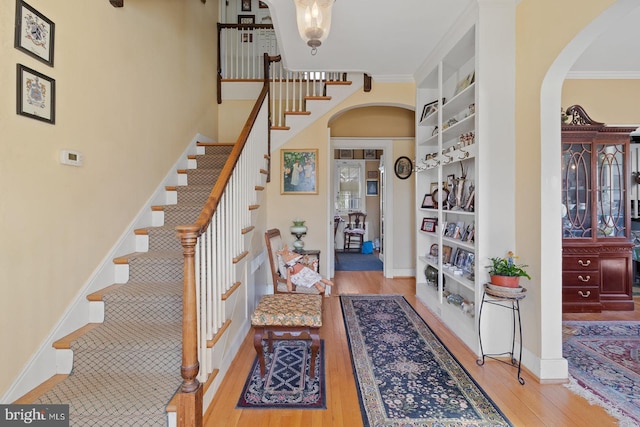 entrance foyer featuring light wood-type flooring and crown molding