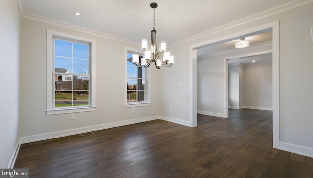 empty room featuring an inviting chandelier, dark hardwood / wood-style floors, and crown molding