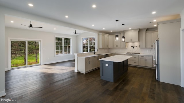 kitchen featuring plenty of natural light, a center island, pendant lighting, and ceiling fan