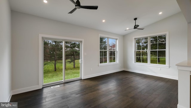 empty room featuring ceiling fan, dark wood-type flooring, and vaulted ceiling