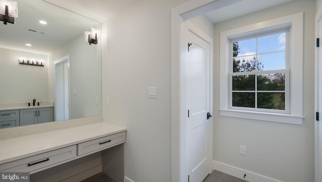 bathroom with tile patterned flooring and vanity