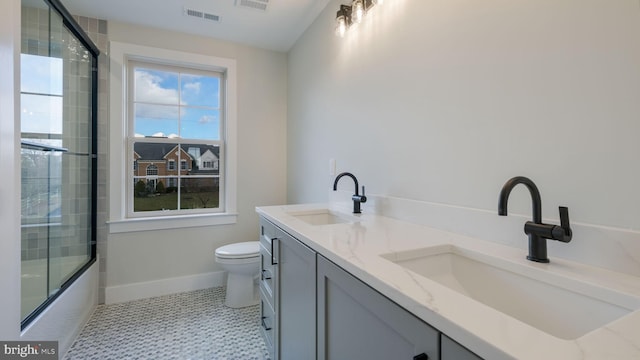 full bathroom with vanity, tile patterned flooring, toilet, and combined bath / shower with glass door