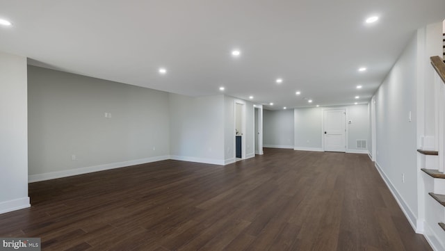 unfurnished living room featuring dark wood-type flooring