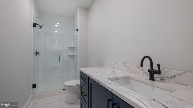 bathroom with an enclosed shower, vanity, and toilet