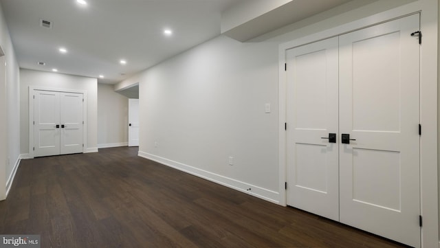 corridor with dark hardwood / wood-style flooring