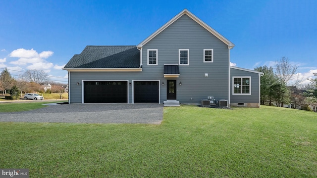 exterior space with a front yard, a garage, and central air condition unit