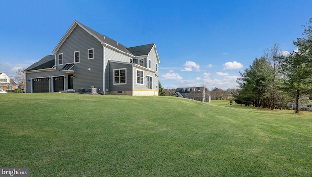 rear view of house featuring a lawn and central air condition unit