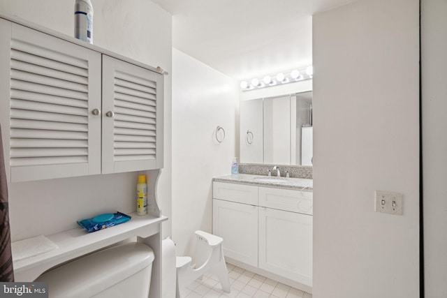 bathroom with vanity, tile floors, and toilet