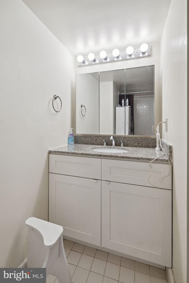 bathroom featuring tile floors and large vanity